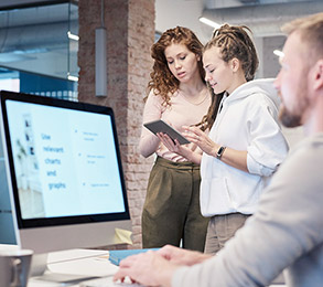 Two colleagues learning together over a tablet