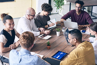 Team reviewing work together around a table